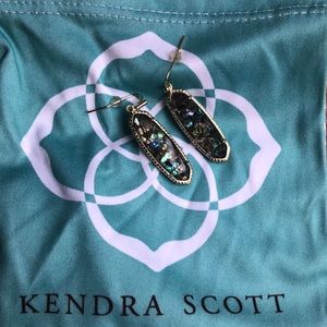 KENDRA SCOTT crushed abalone in gold earrings.